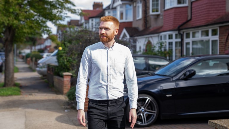 Danny Beales walks down a residential street