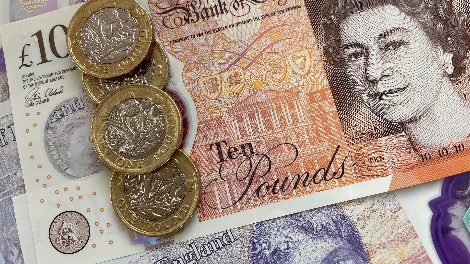 Ten pound note, twenty pound note and three pound coins