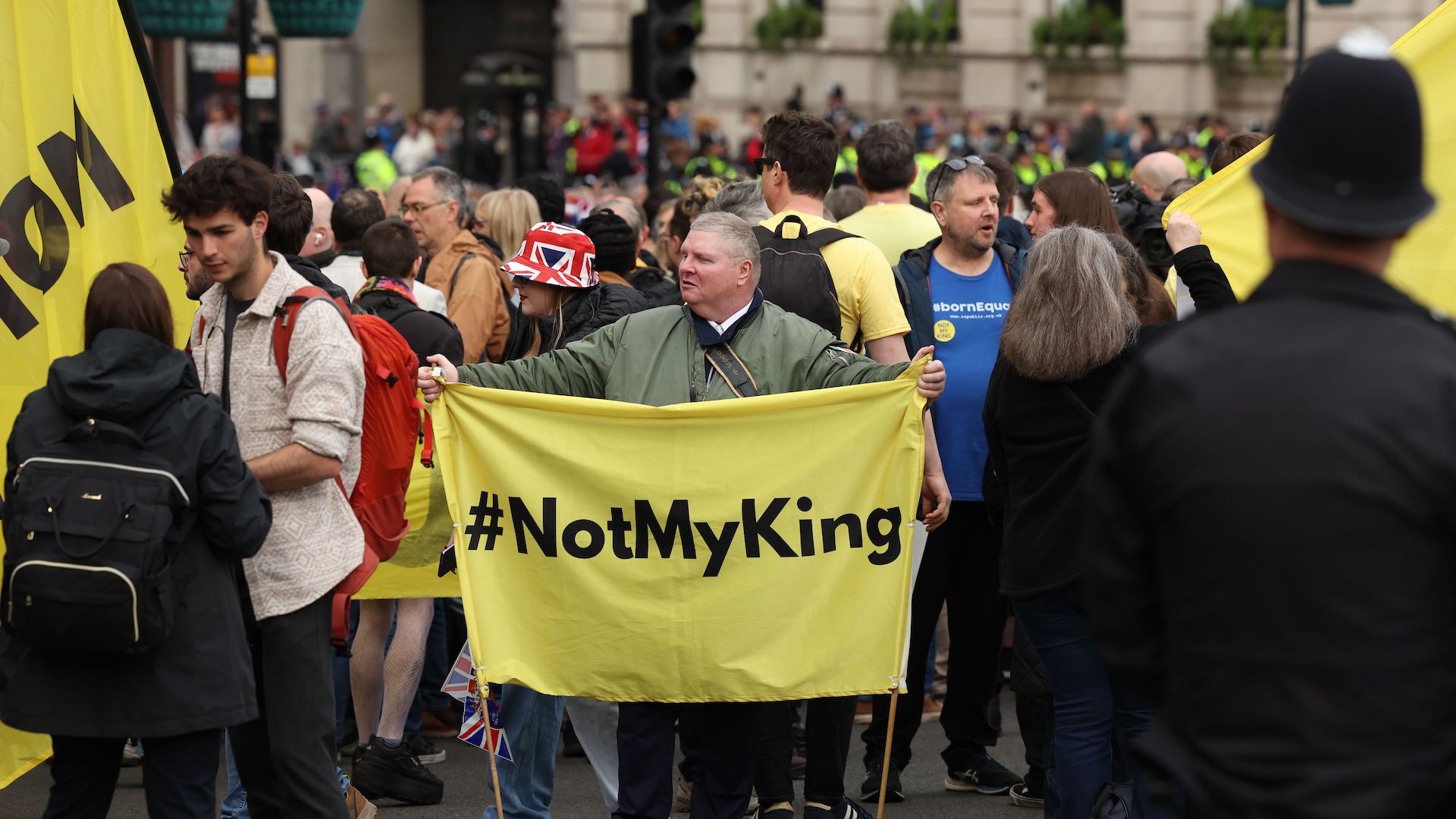 A police officer watches members of the anti-monarchy group Republic protesting on the day of the Coronation of Britain's King Charles III.