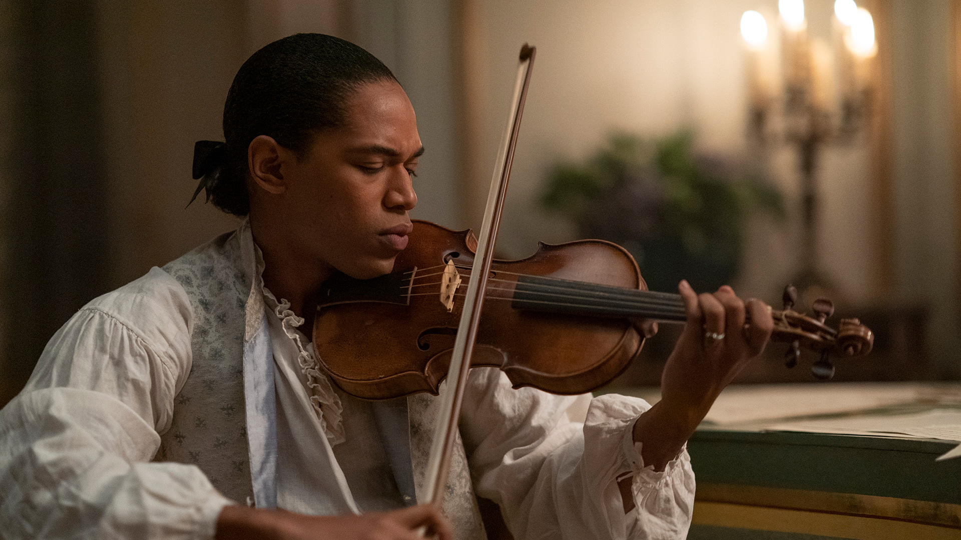 Kelvin Harrison Jr as Joseph Bologne playing a violin