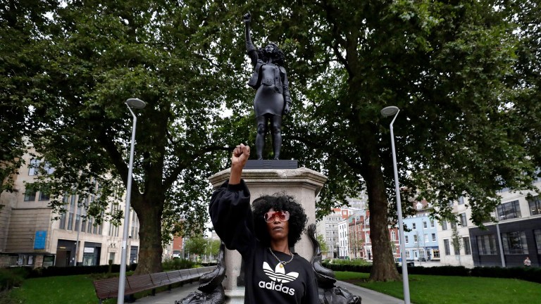 jen reid bristol protests. Jen Reid stands in front of the new black resin and steel statue portraying her