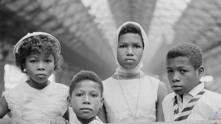 Four children at a train station