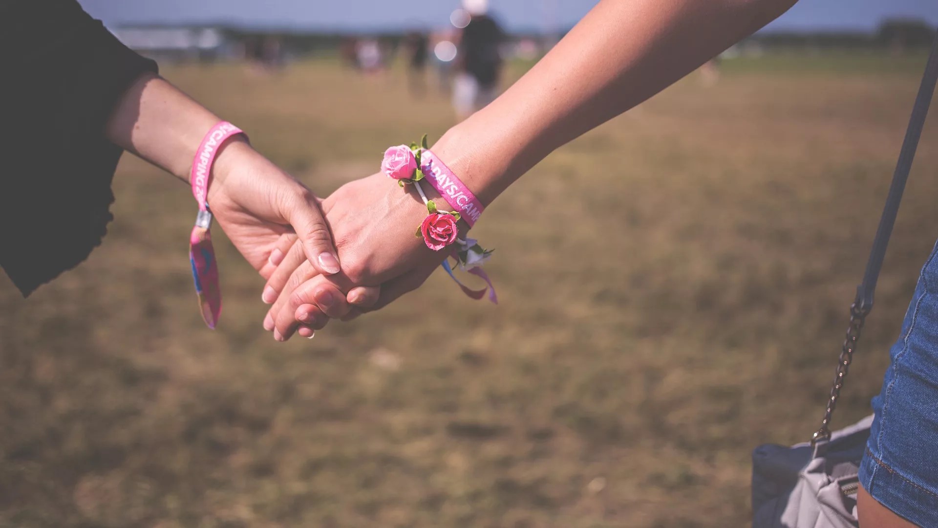 Two young people holding hands