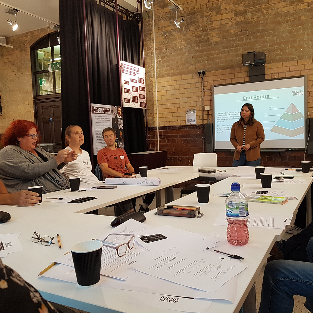 Emily McChrystal speaking to the project participants (brown shirt)