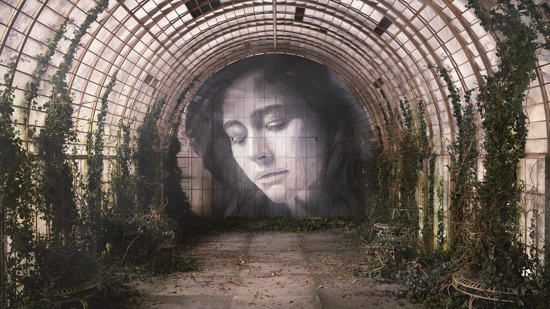 Mural of a woman's face in a decaying urban space