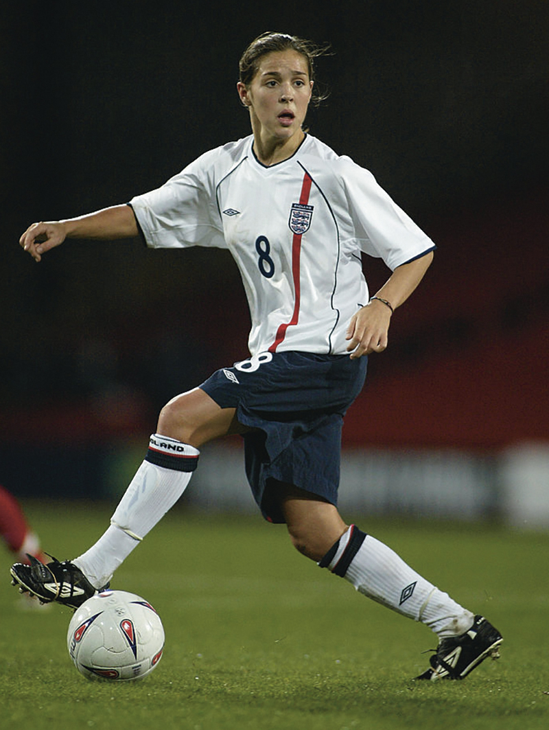 Fara Williams dribbles a ball on the pitch