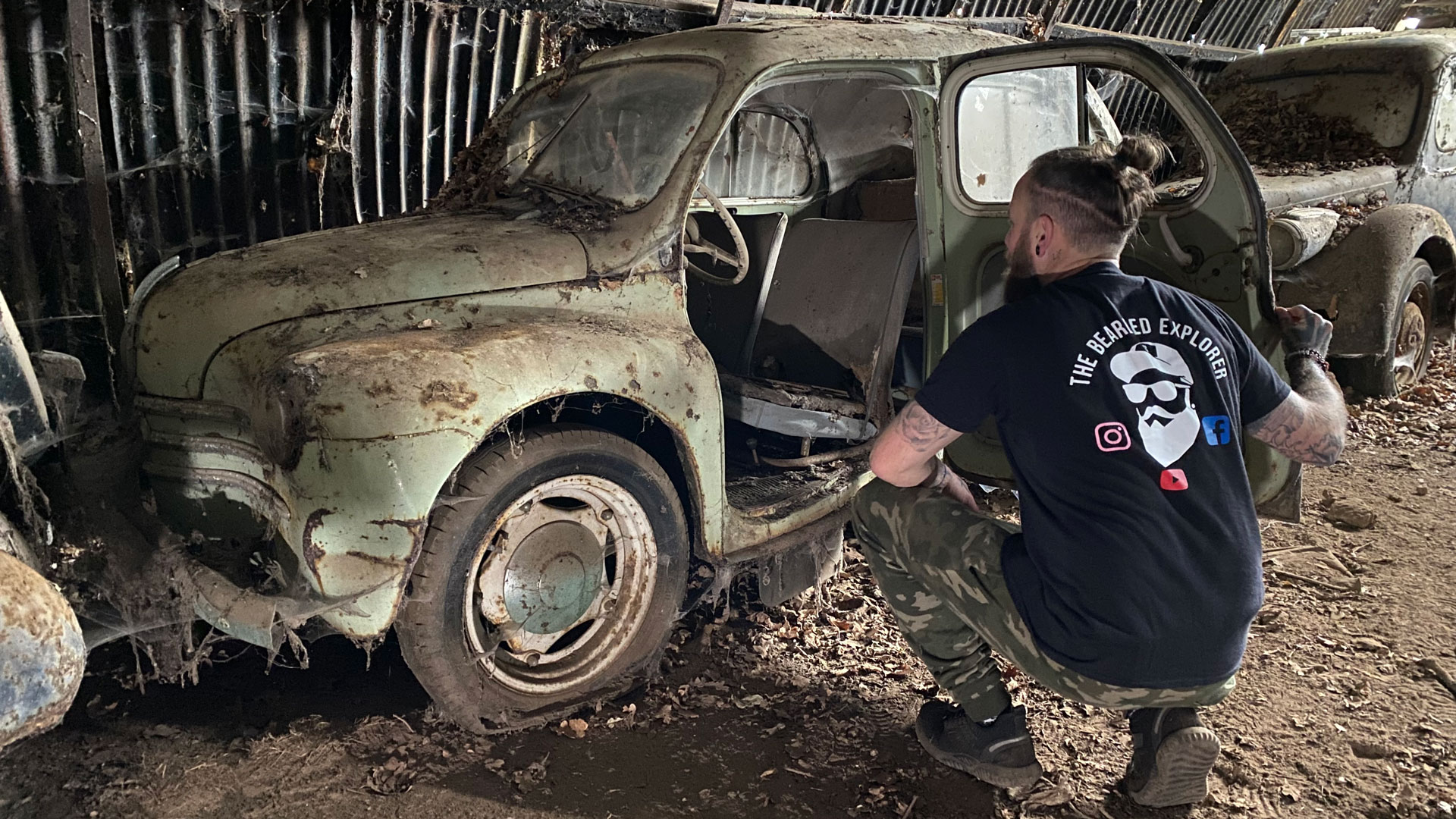 The Bearded Explorer examine a car