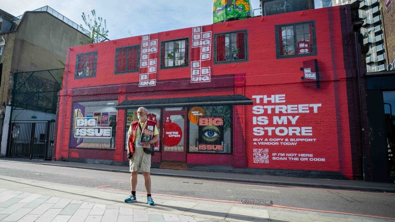 Big Issue seller Paul Logan at Big Issue mural in London