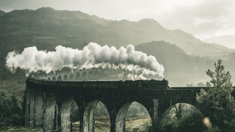 Steam train going over a viaduct