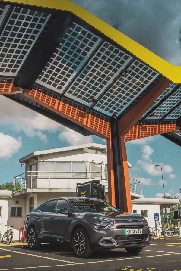 The Citroën ë-C4 X Electric parked at a charging station.