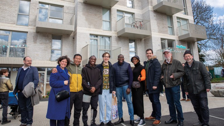 People standing in front of a new build