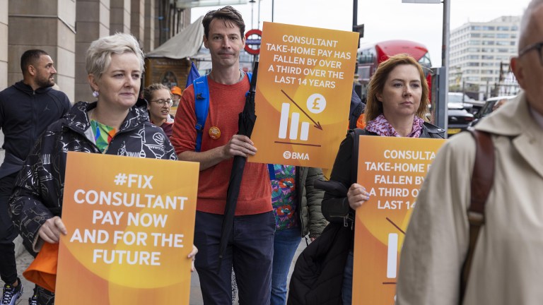 Striking junior doctors holding banners