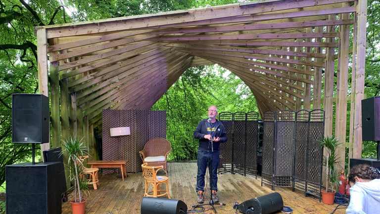 Robin Ince on a wooden stage