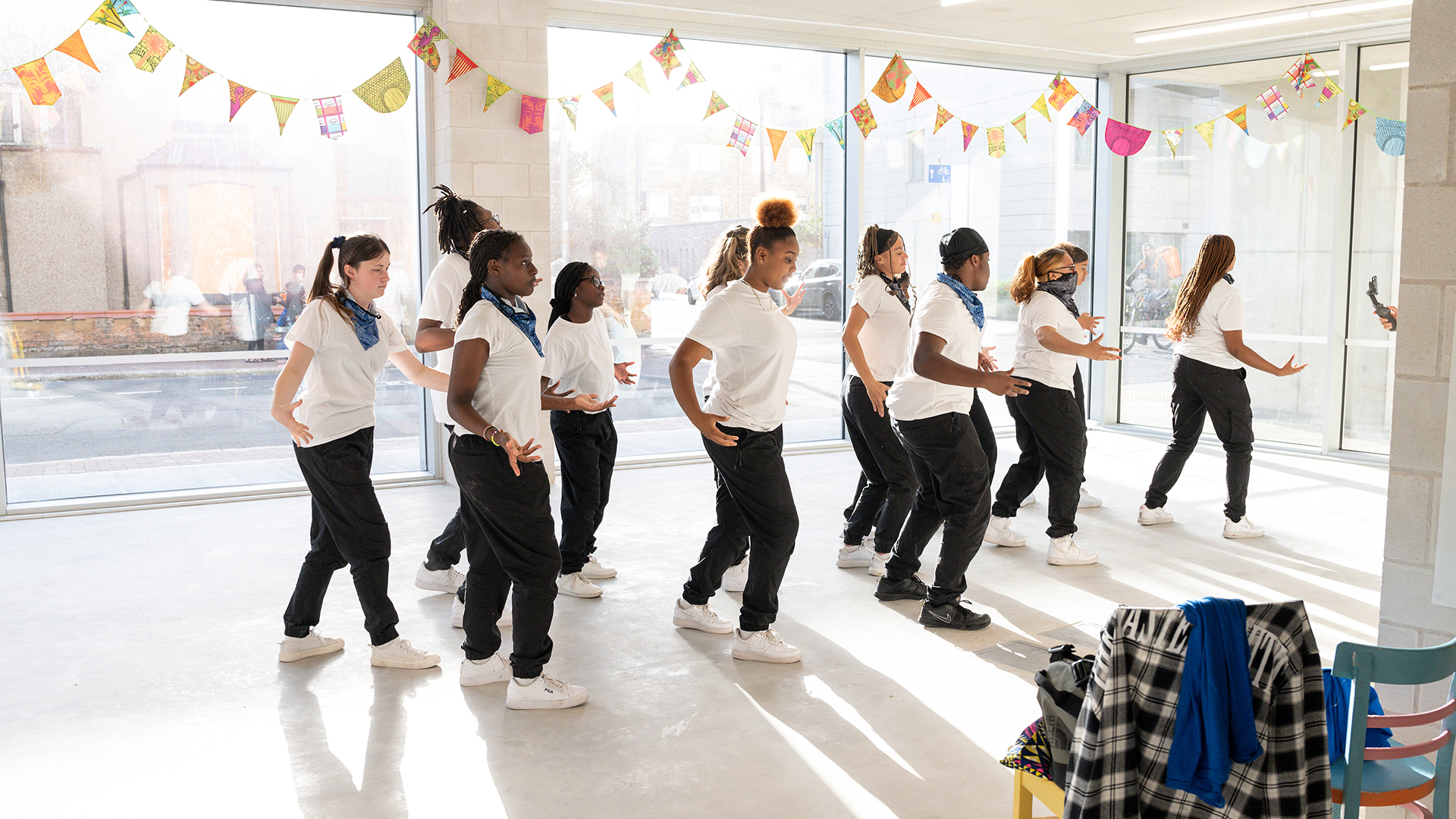 People dancing in a light filled room