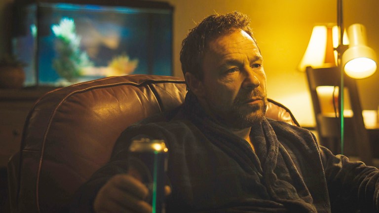 Stephen Graham in a dressing gown with a can of beer