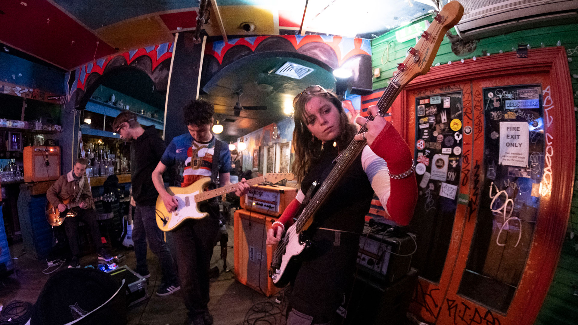 Members of Black Midi and Black Country, New Road in front of the gold curtain at the Windmill Brixton