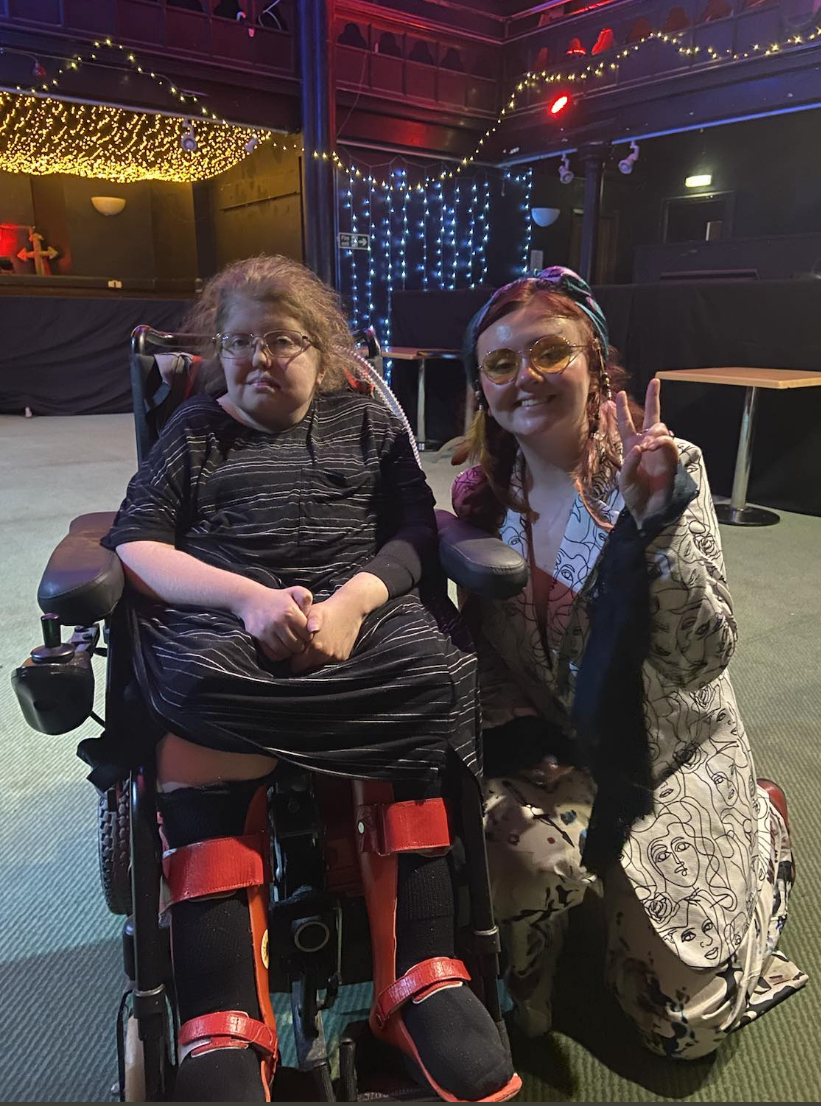 Isabel Headon in a wheelchair with singer Megan Black in MacArts