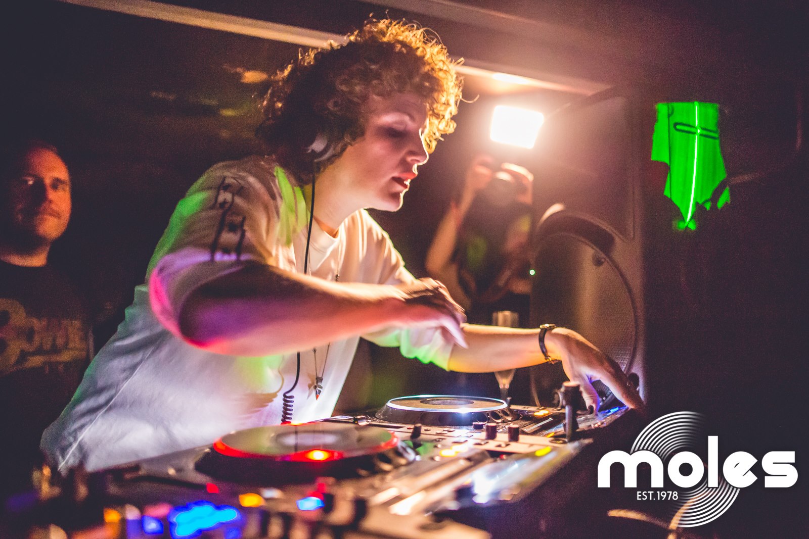 Annie Mac wearing headphones with her decks