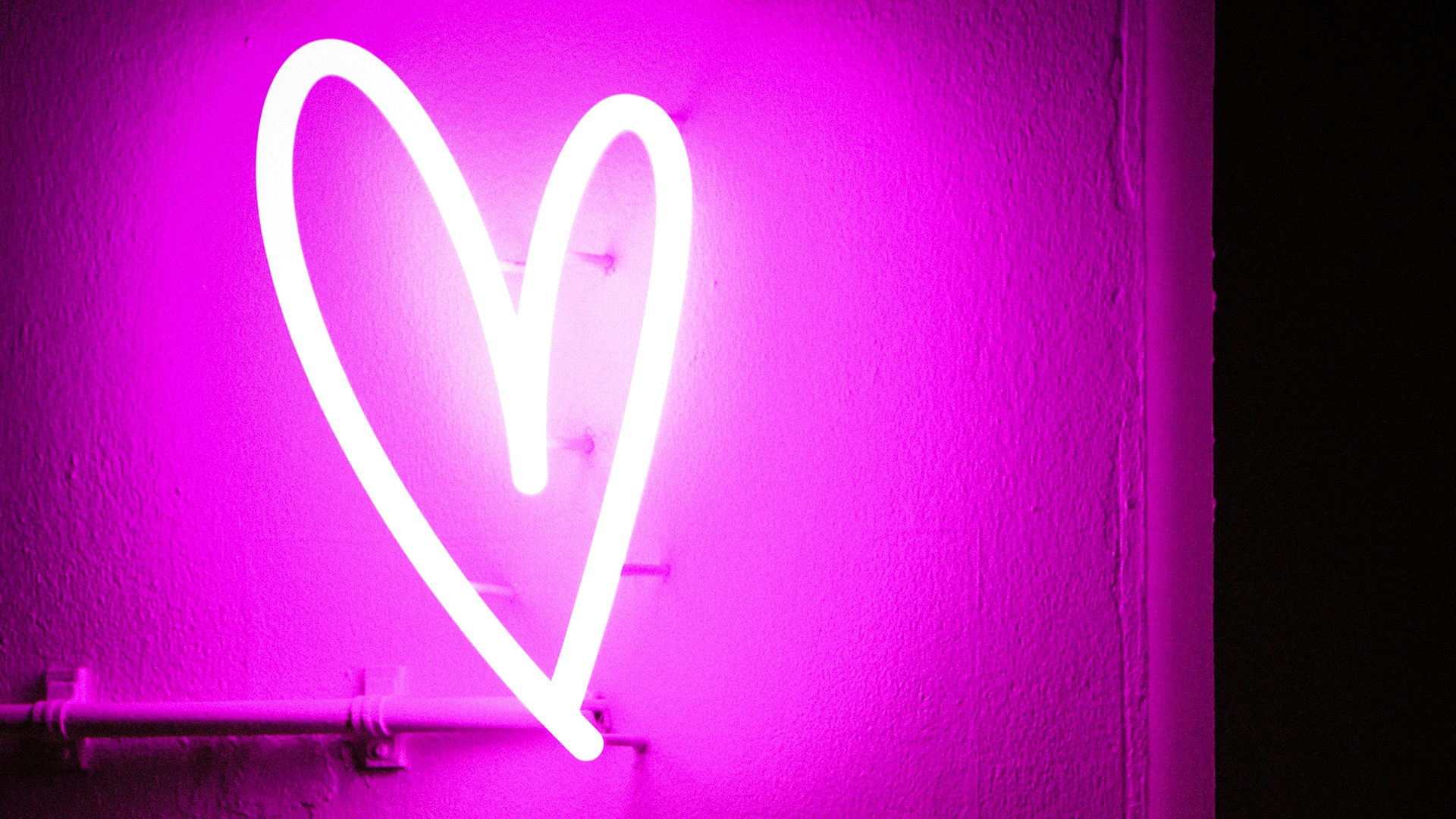 Pink neon light in the shape of a heart