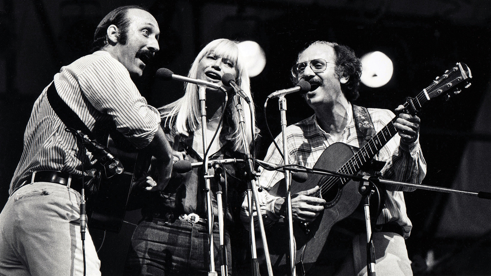 Peter, Paul and Mary around microphones