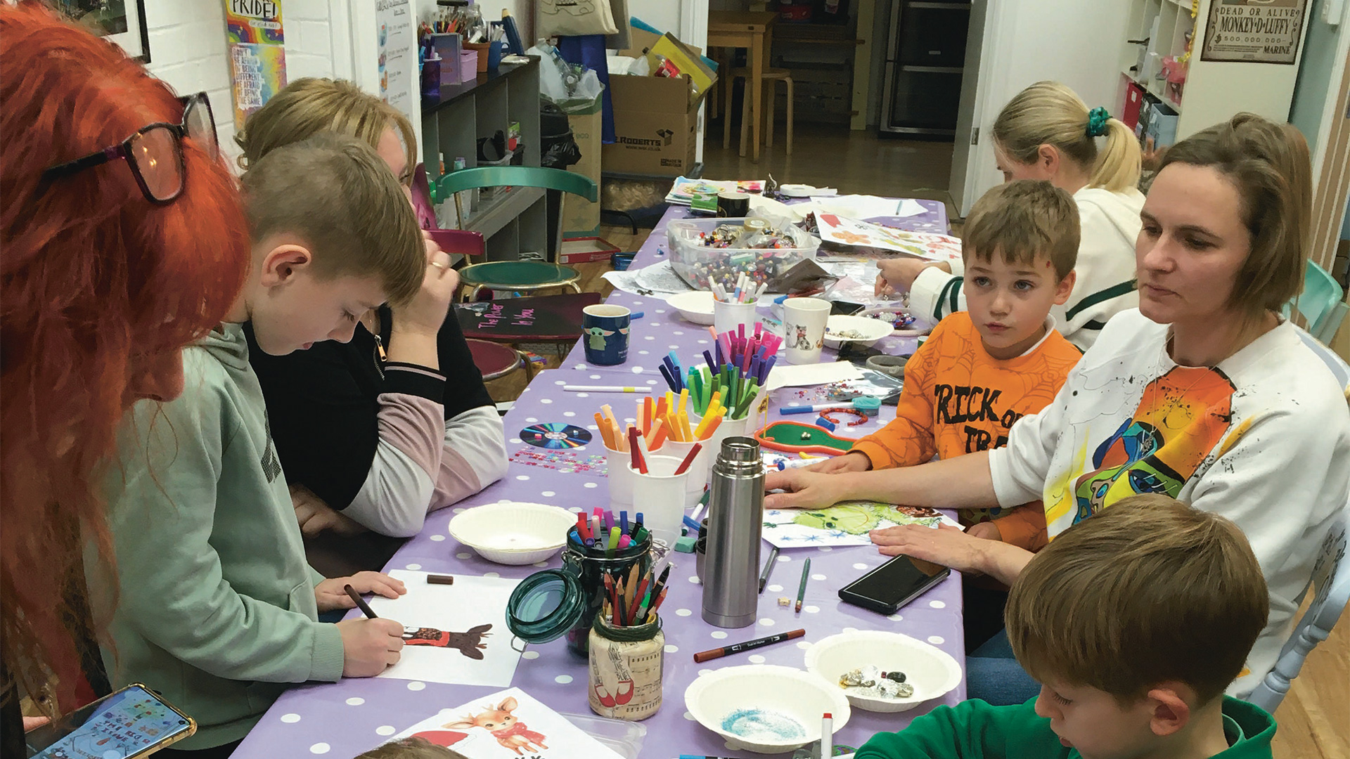 Children painting around a table