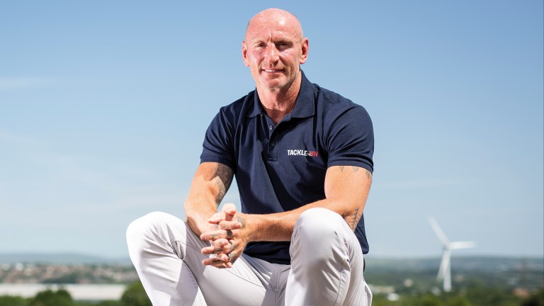 Seated Gareth Thomas in a navy t-shirt