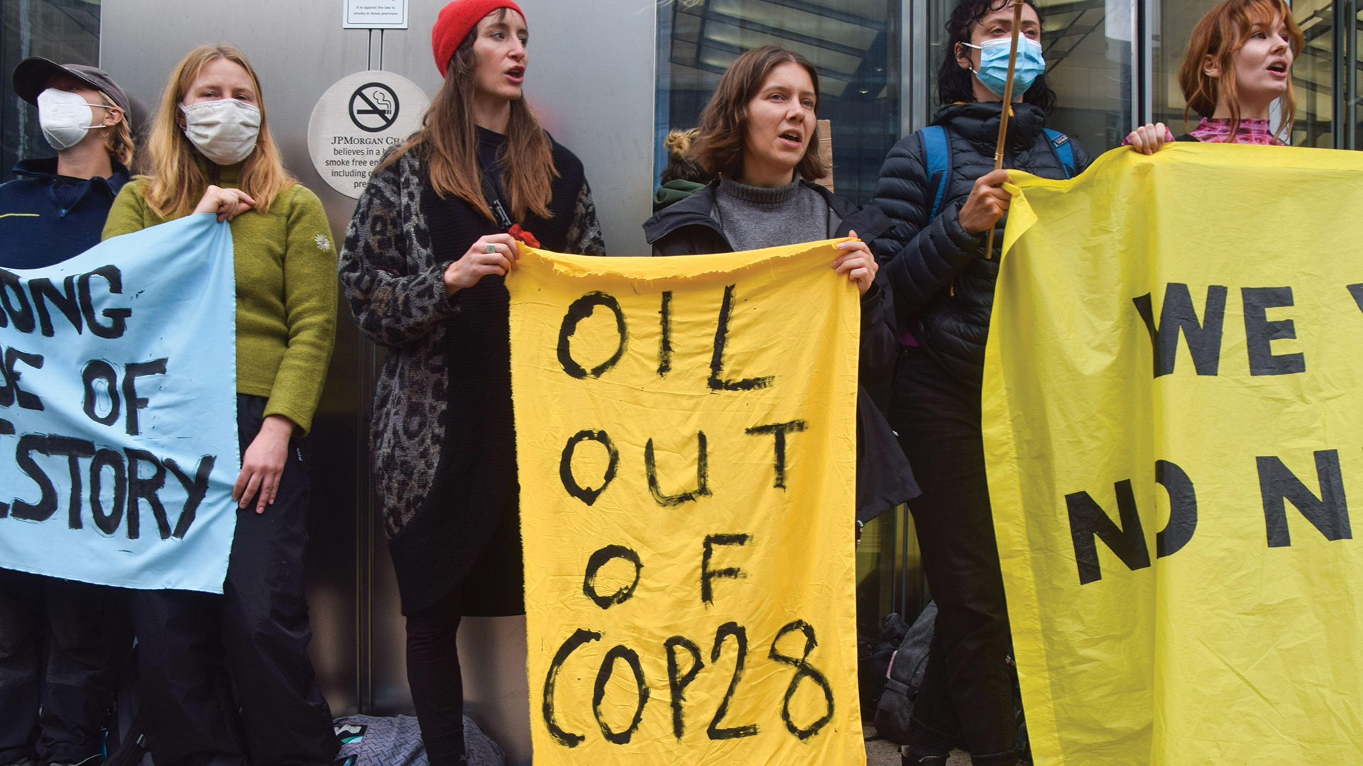 Protesters carrying banners against fossil fuels