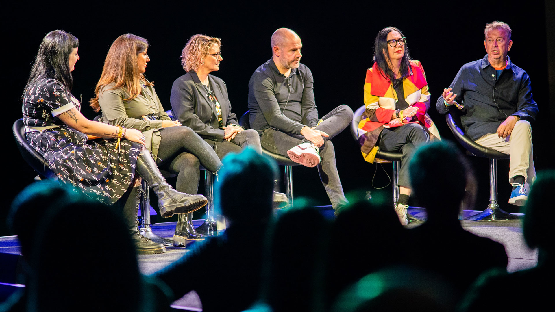 Six people sitting talking onstage at the Beyond the Music conference