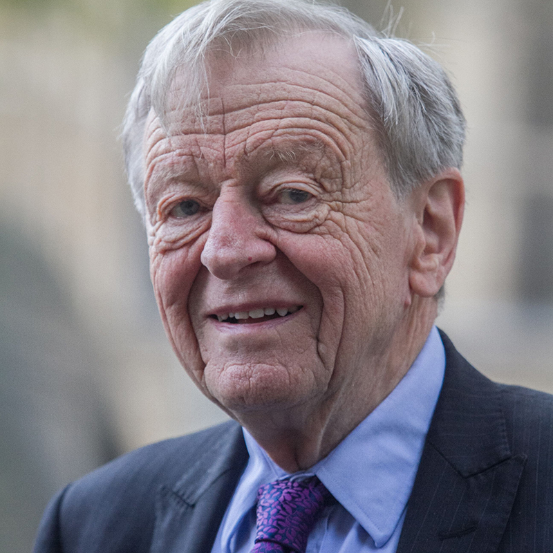 one-time refugee Lord Dubs in a blue shirt and tie and navy jacket