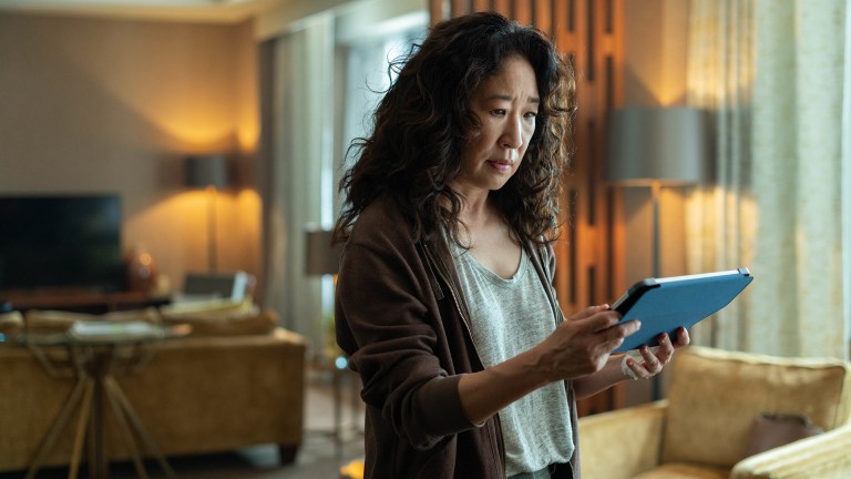 Sandra Oh looks at an ipad