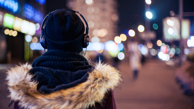 teen walks away into nightime cityscape