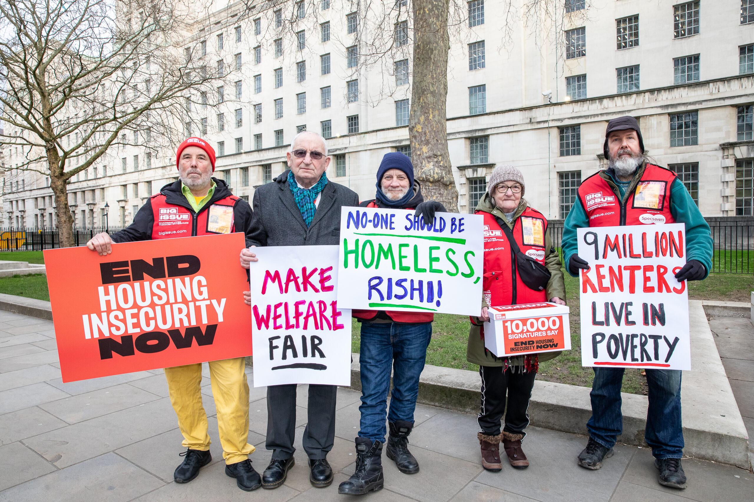 A group of vendors stand on Whitehall, London, calling on the Government to end housing insecutiry.