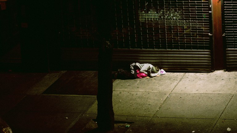 a person sleeping on a dark street