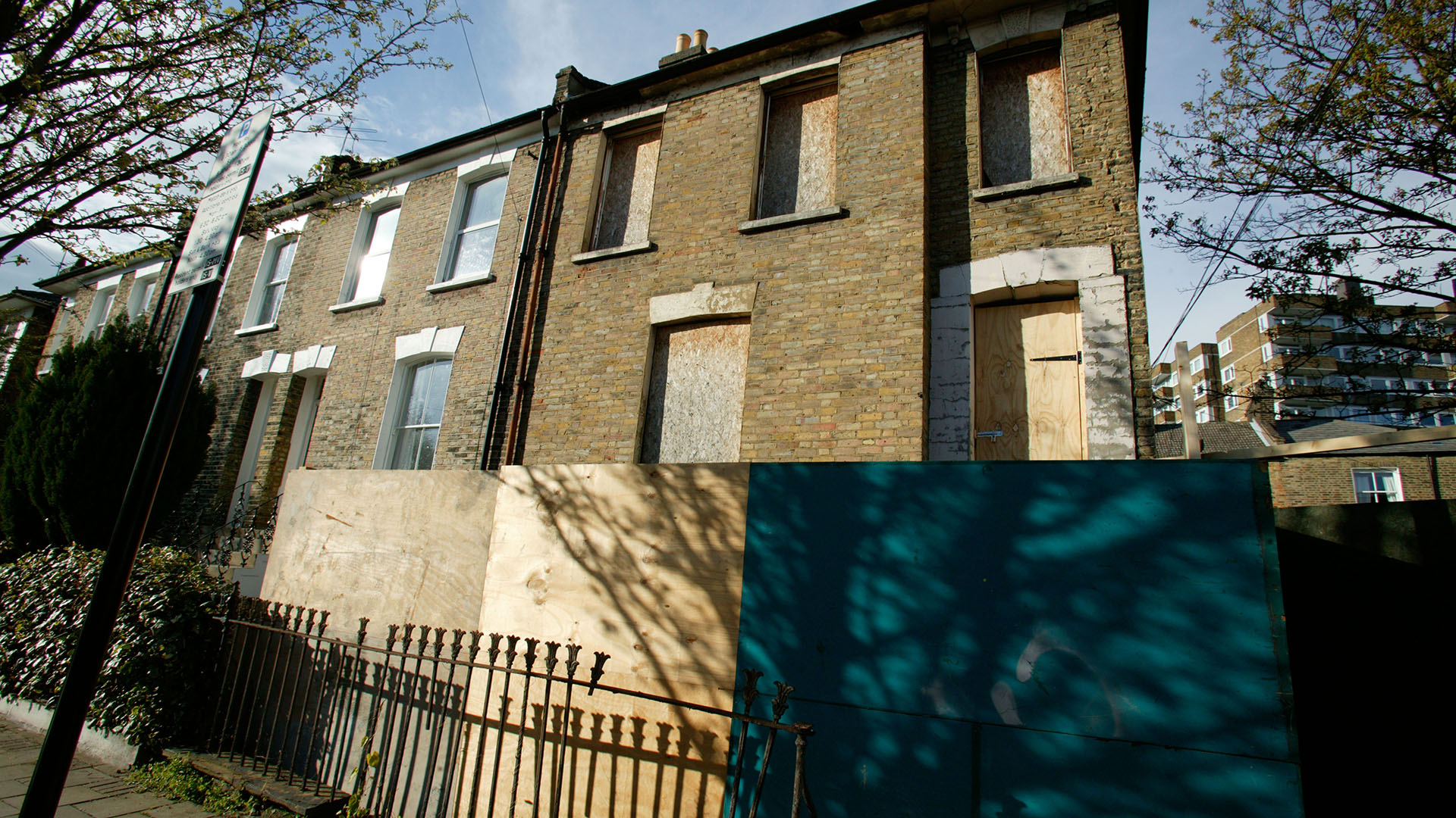 Boarded-up empty end-of-terrace house in north london.