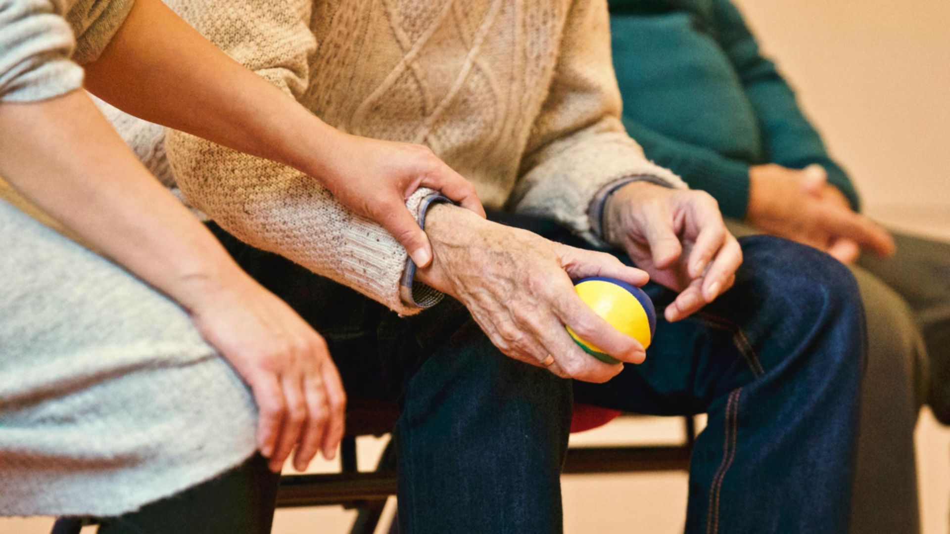 Image of carer holding elderly person's hand