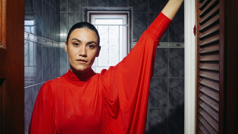 Nadine Shah wearing a red dress