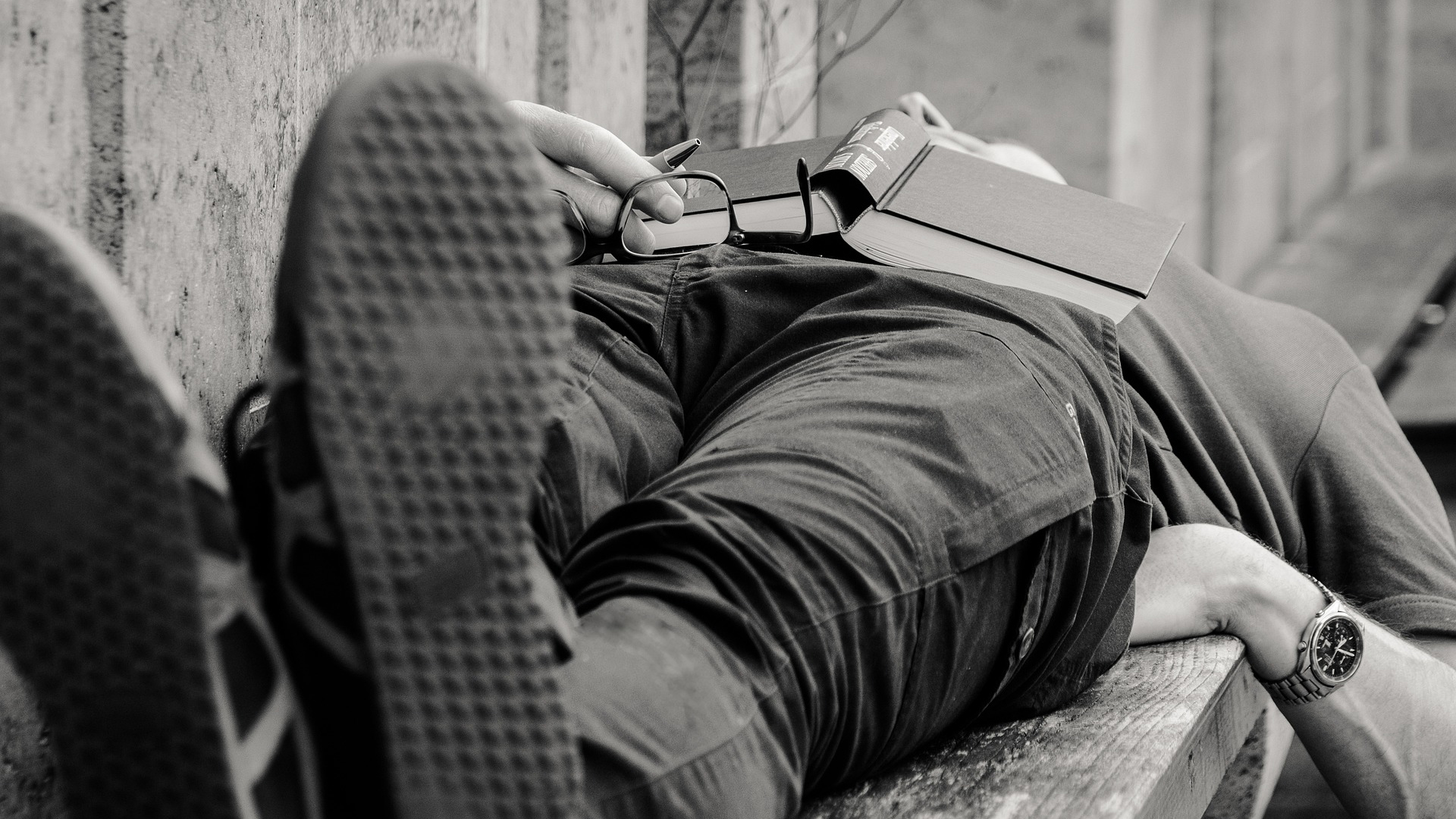 A man having a nap on a bench