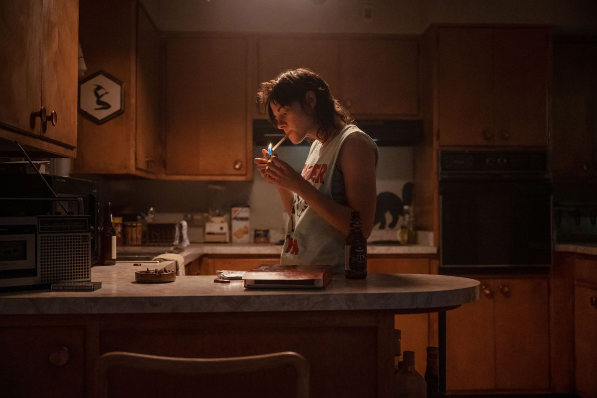 Kristen Stewart smoking in a kitchen in Love Lies Bleeding