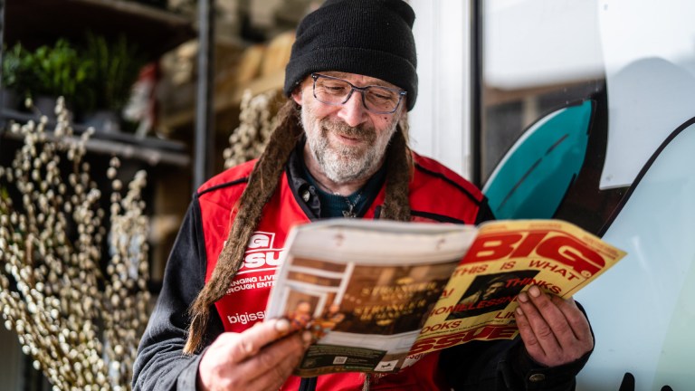 Street vendor Will Payne reads the Big Issue - Credit Exposure Agency