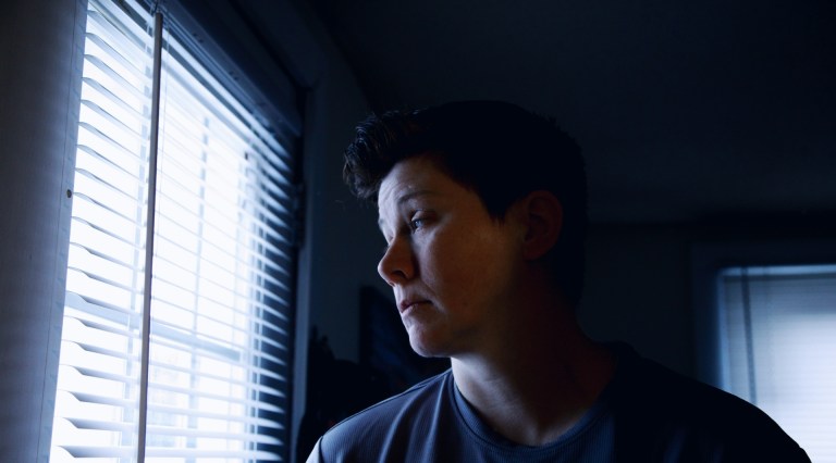 person looking out of window
