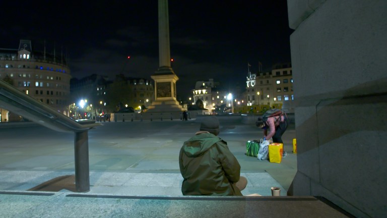 A homeless man sleeping rough at Trafalgar Square