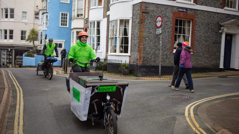 A person on a bile rides down a street