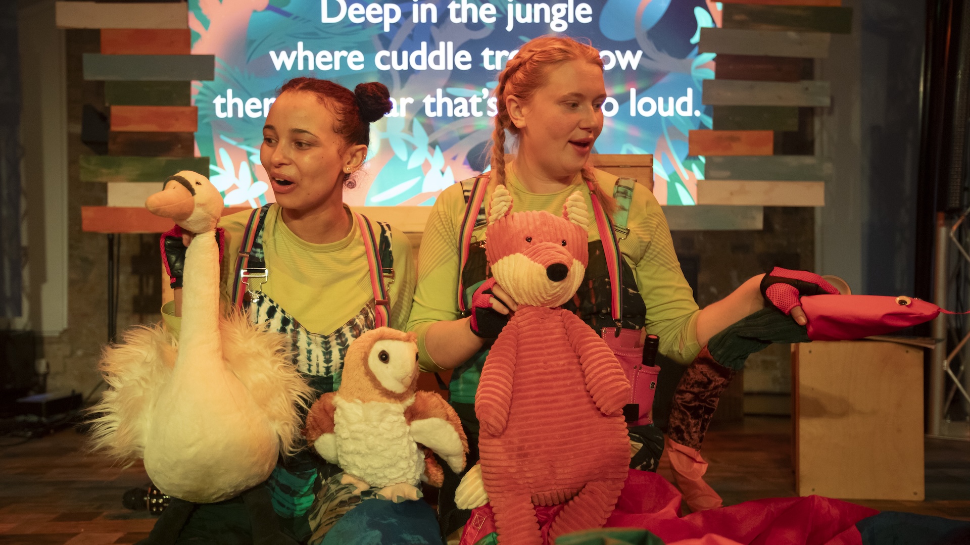 The Noisy Dinosaur production from Toucan Theatre. Image of two cast members with jellycats