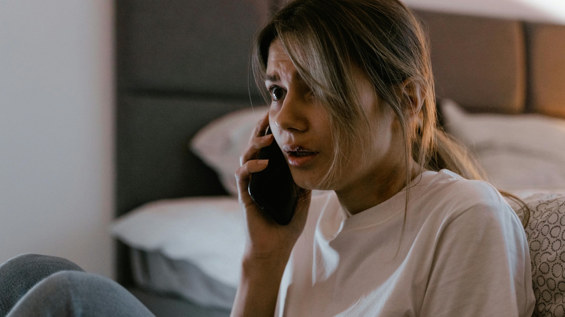 a person looking scared on a phone call