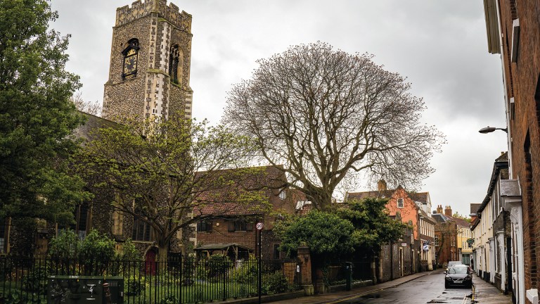 St Georges Church on the corner of Colegate and Magdalen Street in the city of Norwich, Norfolk captured on a dull and wet Sunday.