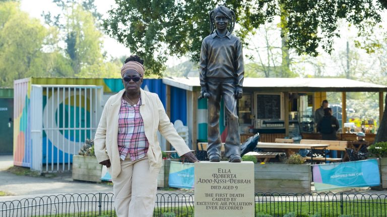 Rosamund Adoo-Kissi-Debrah stands with a statue of her daughter, Ella