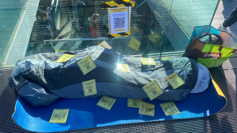 Humans Parked Illegally Vagrancy Act installation showing fake parking fines on a sleeping bag