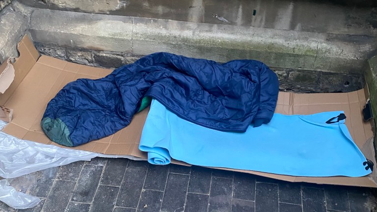 Cardboard and a sleeping bag, on the church premises where Joseph is sleeping