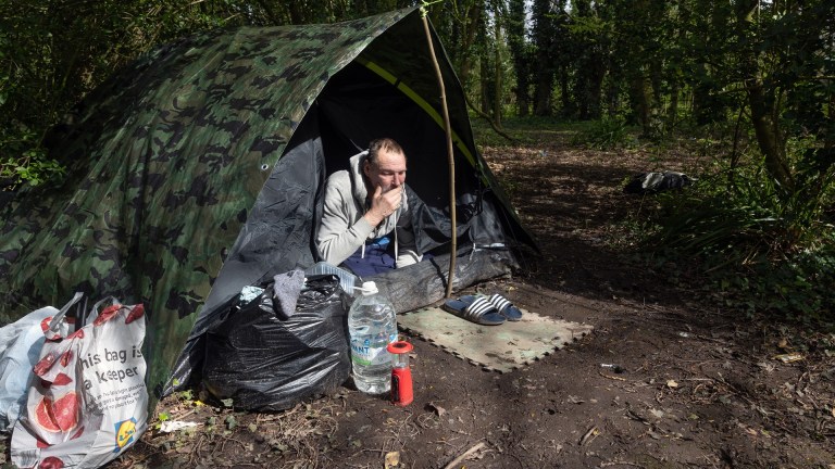 a man in a tent in the woods