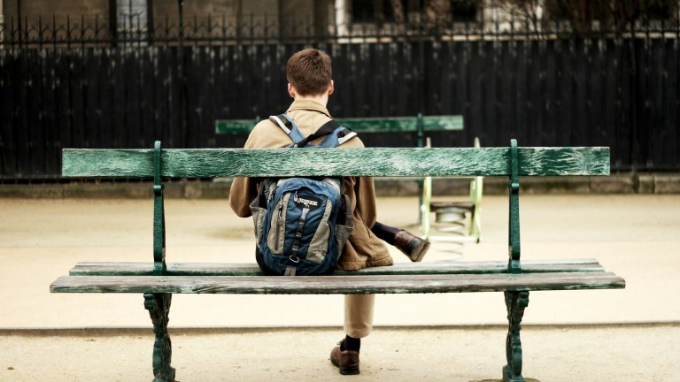 a young person sat on a bench